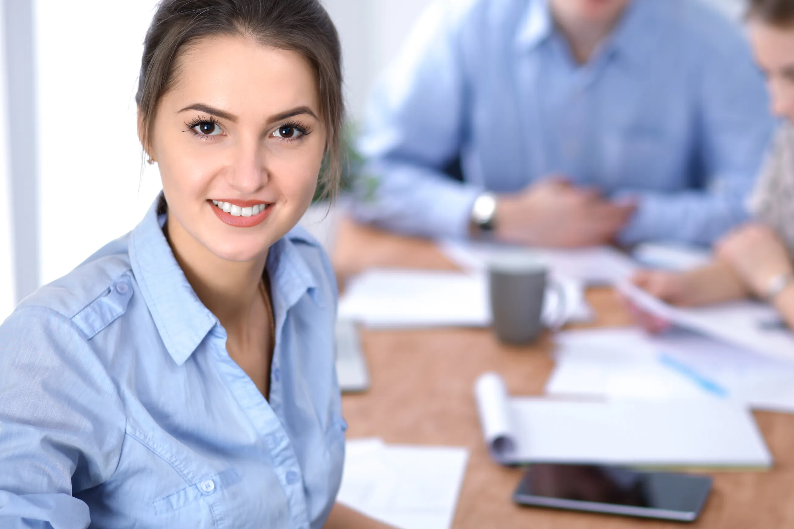 Beautiful business woman on the background of business people with Corporate work uniforms