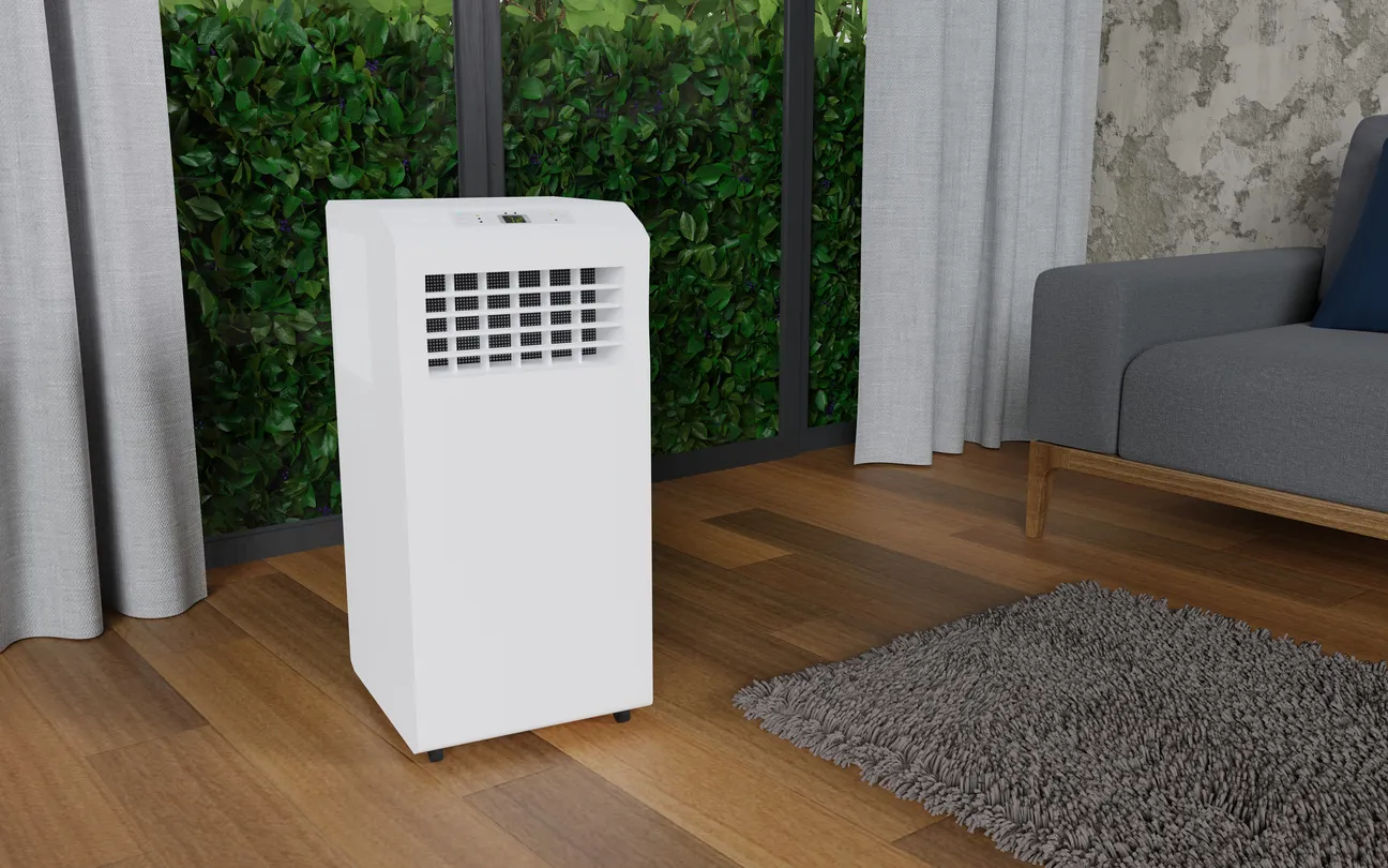 Aire acondicionado móvil en una habitación con una gran ventana, sofá gris, cortinas grises, suelo de parquet de madera.