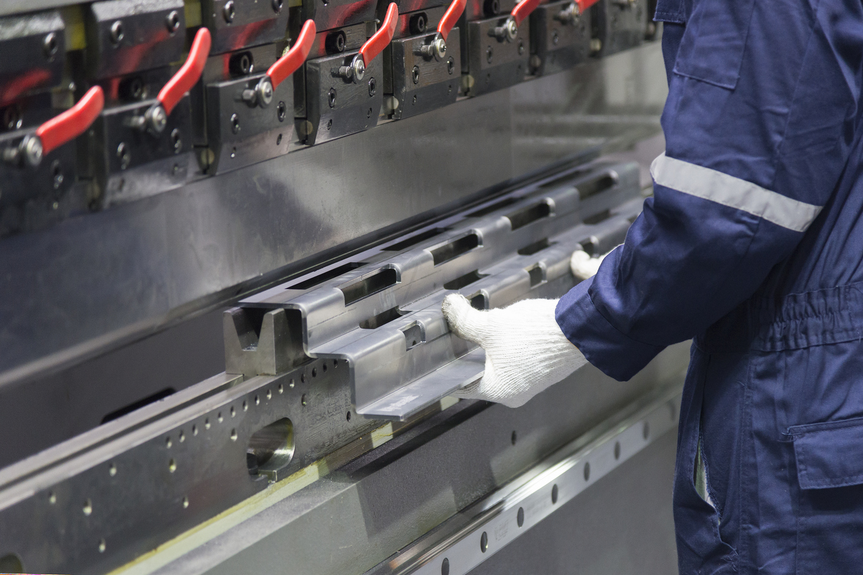 El operador técnico utiliza una máquina dobladora hidráulica.