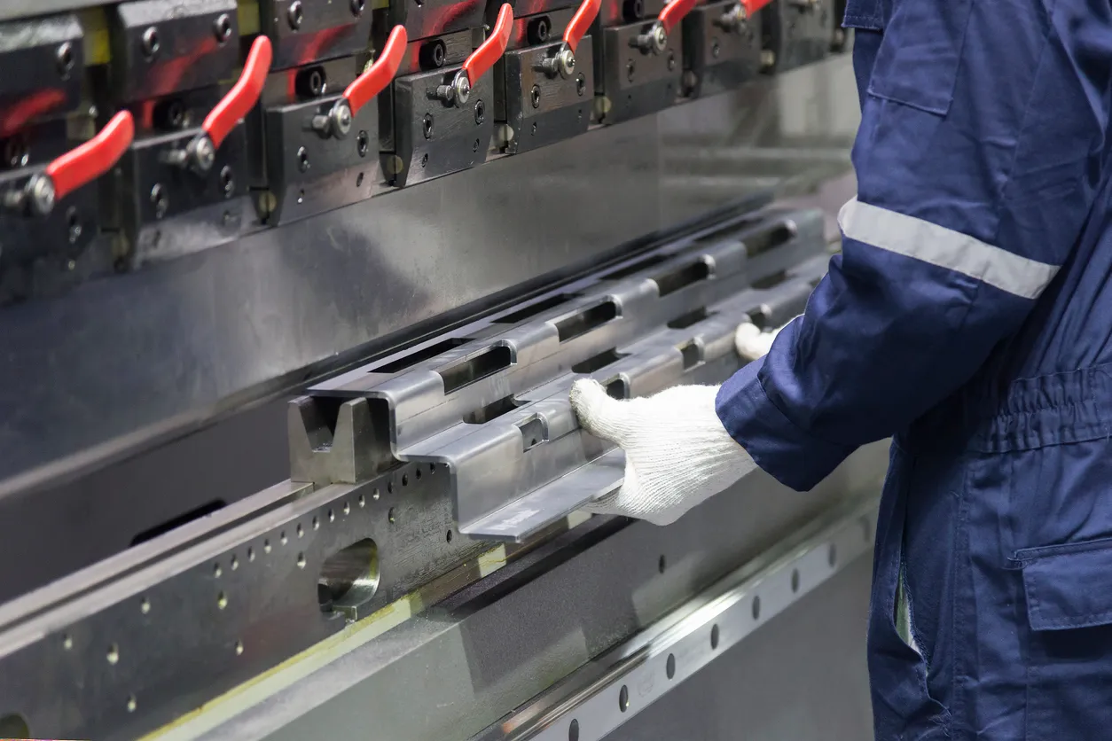 El operador técnico utiliza una máquina dobladora hidráulica.