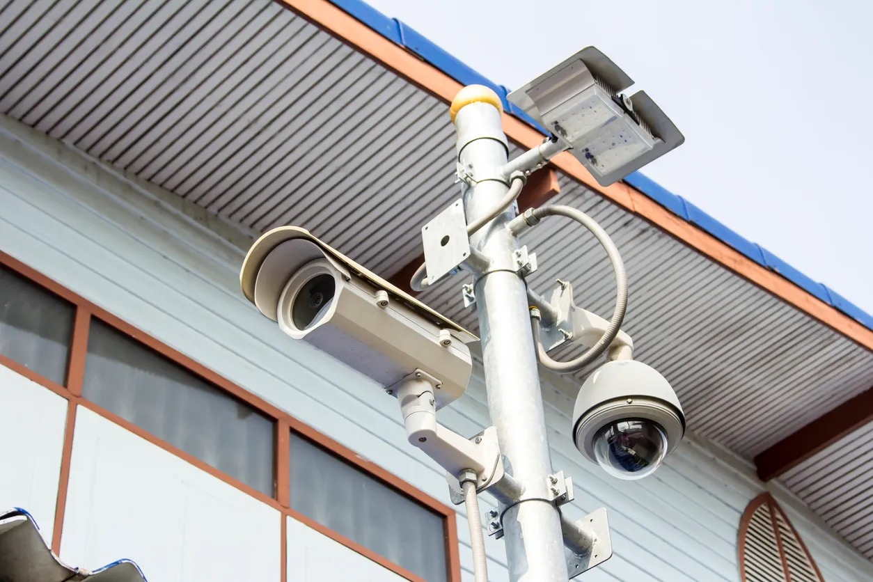 Cámara de vigilancia CCTV en el poste con fondo de pared por concepto de seguridad.