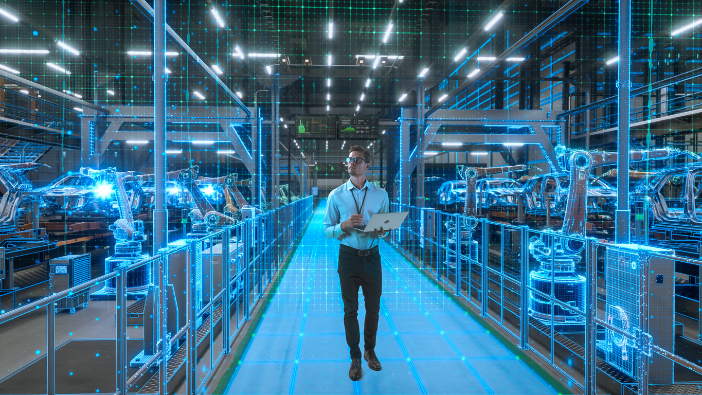 Un ingeniero con computadora portátil activa la digitalización de la fábrica autónoma de vehículos eléctricos.