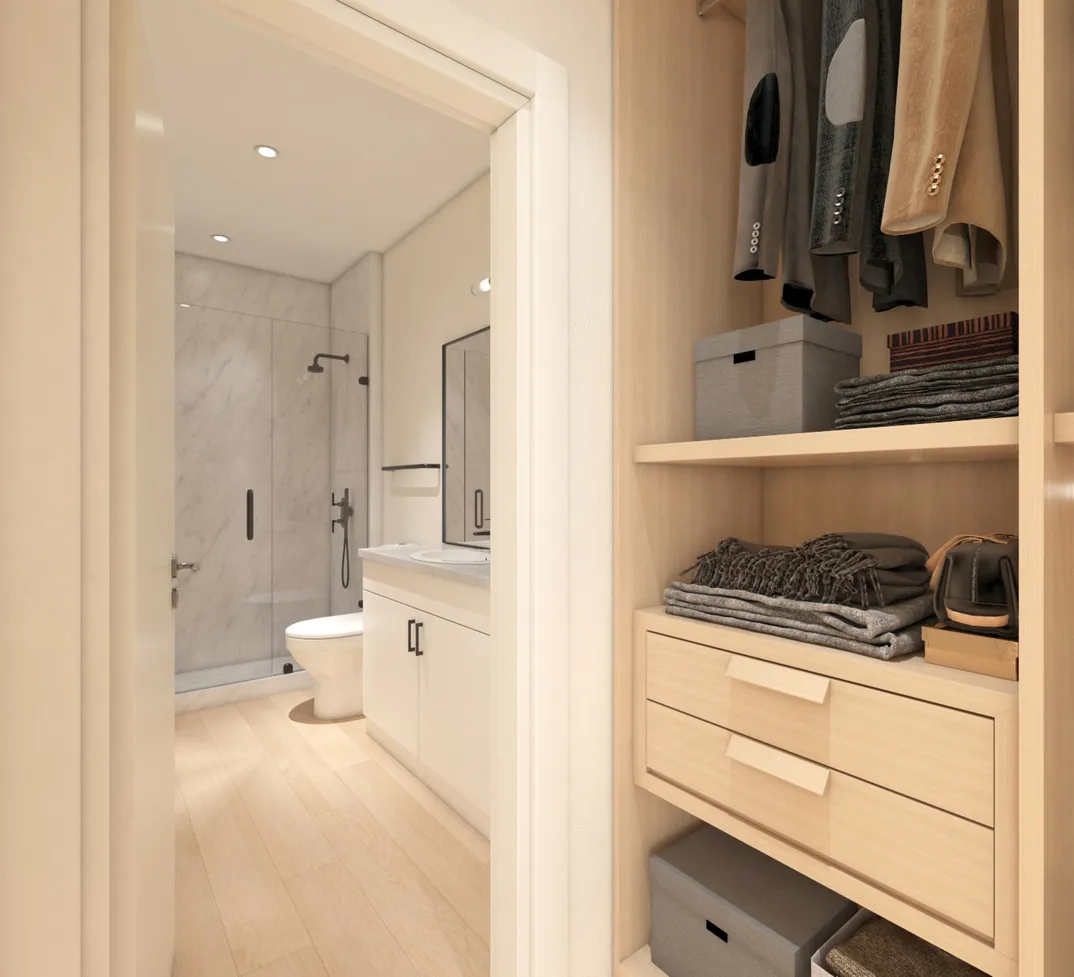 armario bien organizado que da acceso a un elegante baño con ducha de mármol. Baño con clóset